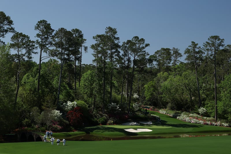 Fred Couples, Brooks Koepka, Justin Thomas and Adam Scott stand on the Hogan Bridge at the 12th hole during a practice round prior to the 2025 Masters Tournament at Augusta. Photograph: Richard Heathcote/Getty Images
