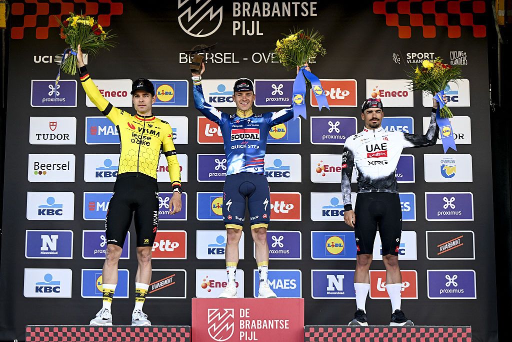 Wout van Aert of Team Visma-Lease a Bike, Remco Evenepoel of Soudal Quick-Step, third placed Portuguese Antonio Morgado of UAE Team Emirates celebrate on the podium after the men's 'Brabantse Pijl'