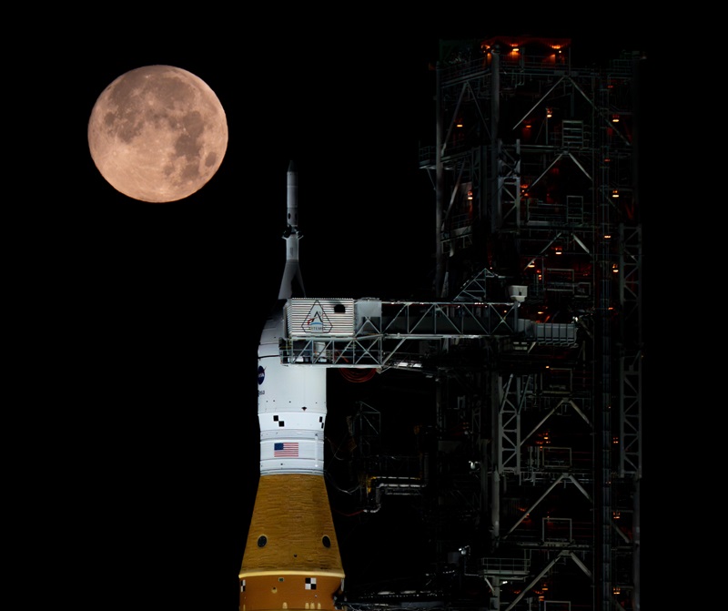 A full Moon is seen setting behind NASA's SLS (Space Launch System) and Orion spacecraft, atop the mobile launcher in the early hours of February 1, 2026. 