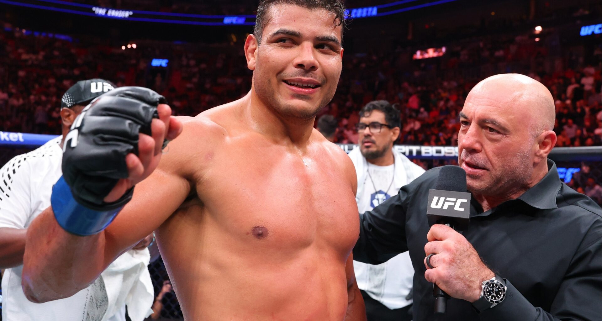 Paulo Costa is interviewed by Joe Rogan in the cage at UFC 327