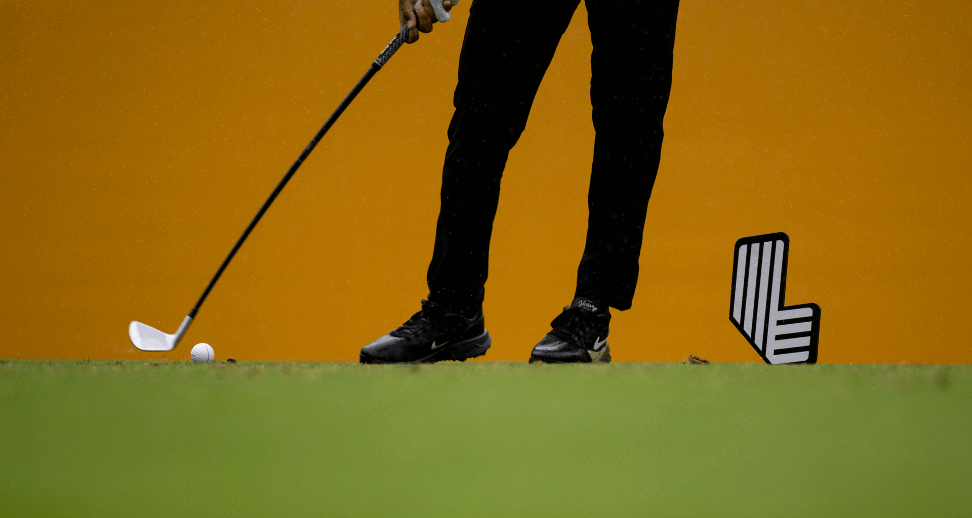A general view of a LIV golfer's legs, club and ball as they tee off at LIV Golf South Africa