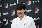 FILE - Portland Trail Blazers first round draft pick Yang Hansen smiles and answers questions during his introductory press conference in the Trail Blazers Practice Facility in Portland, Ore., June 27, 2025.