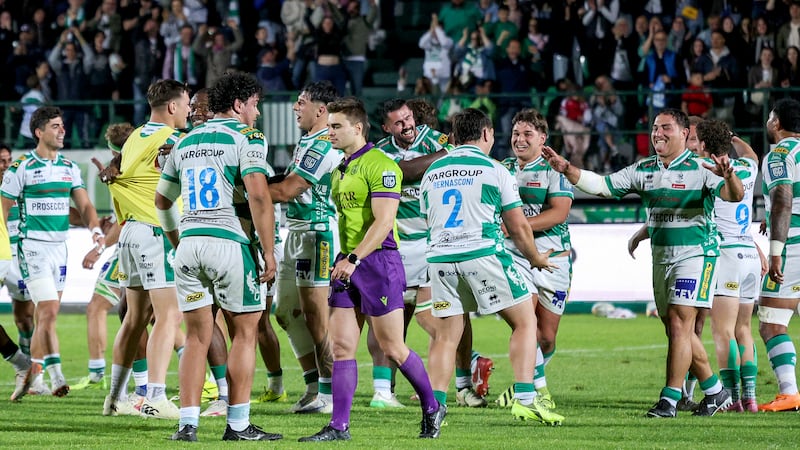 Benetton players celebrate with Jacob Umaga after he kicked a penalty to win Saturday's URC match against Leinster at Stadio Comunale Monigo in Treviso, Italy. Photograph: Roberto Bregani/Inpho