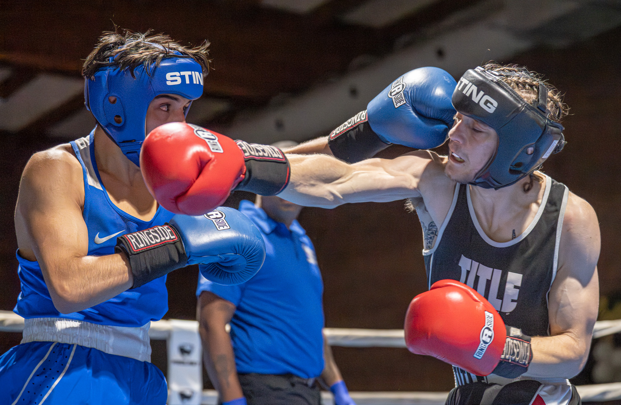 Boxers spar during the third round of a California State...
