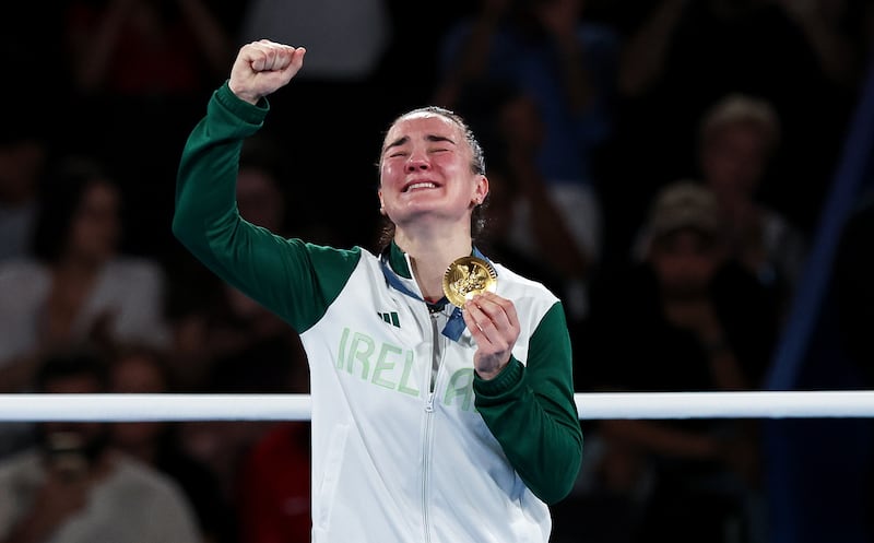 Ireland’s Kellie Harrington celebrates on the podium with her gold medal. Photograph: Ryan Byrne/Inpho