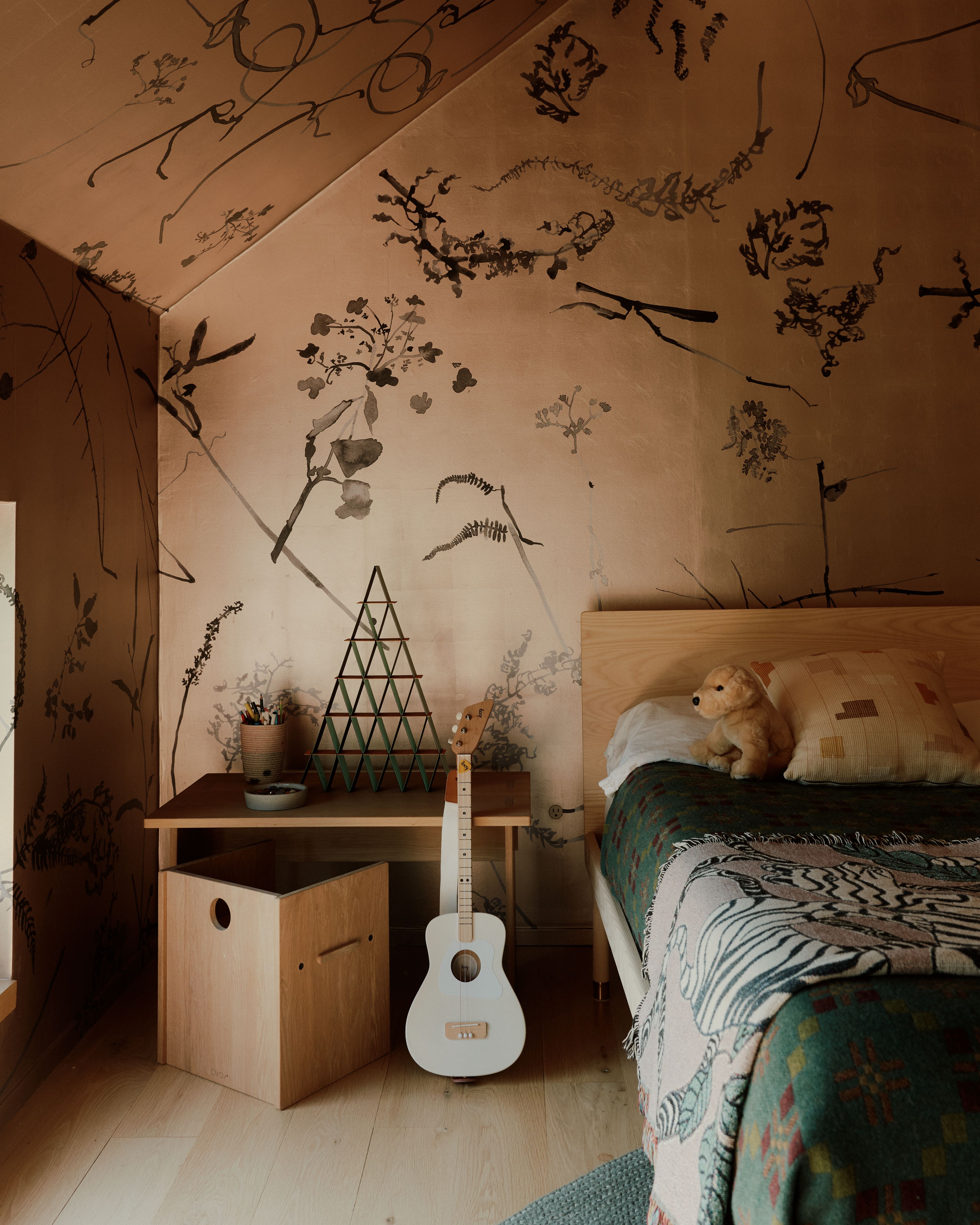 The children's rooms upstairs are covered with playful wallpapers on walls and ceiling, making the rooms into small worlds of their own. 