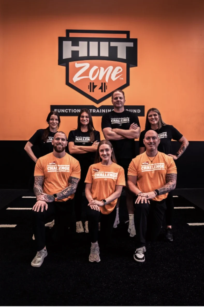 people pose for a photo inside a Crunch Fitness gym