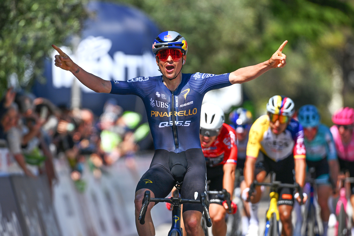 Tom Pidcock celebrates as he crosses the line to win stage 3 of the 2026 Tour of the Alps