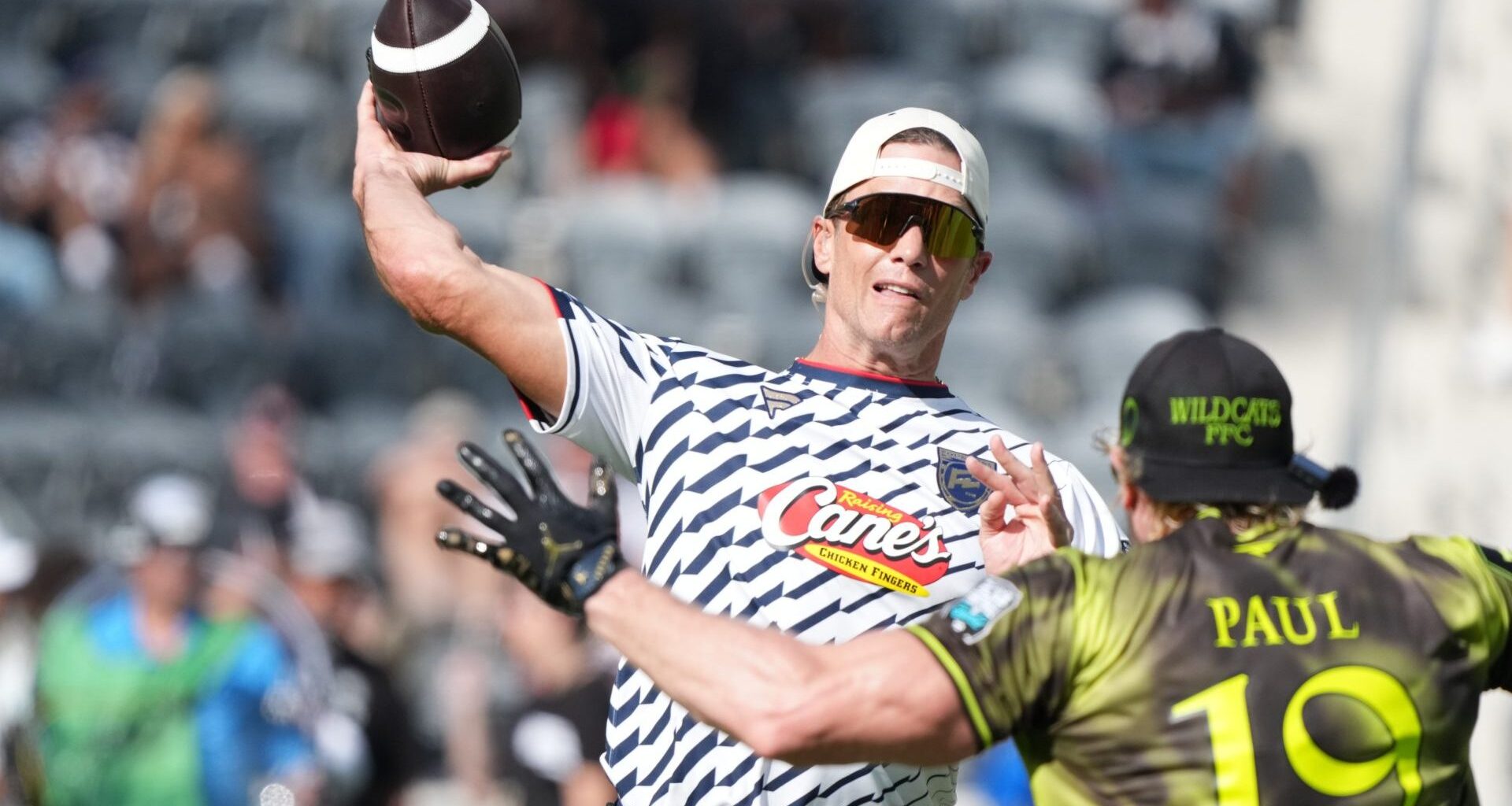 Mar 21, 2026; Los Angeles, CA, USA; Founders FFC quarterback Tom Brady (12) throws ball against Logan Paul of Wildcats FFC during the Fanatics Flag Football Classic at BMO stadium. Mandatory Credit: Kirby Lee-Imagn Images