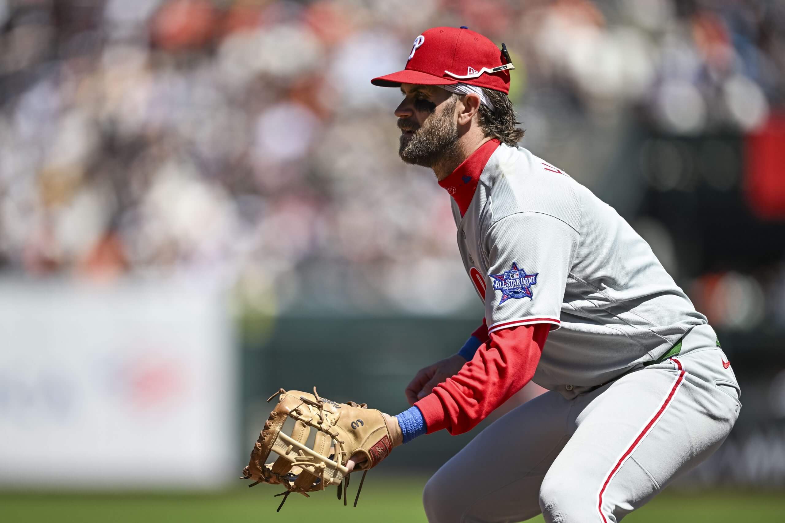Philadelphia Phillies first baseman Bryce Harper stands with his knees bent, ready with his glove.