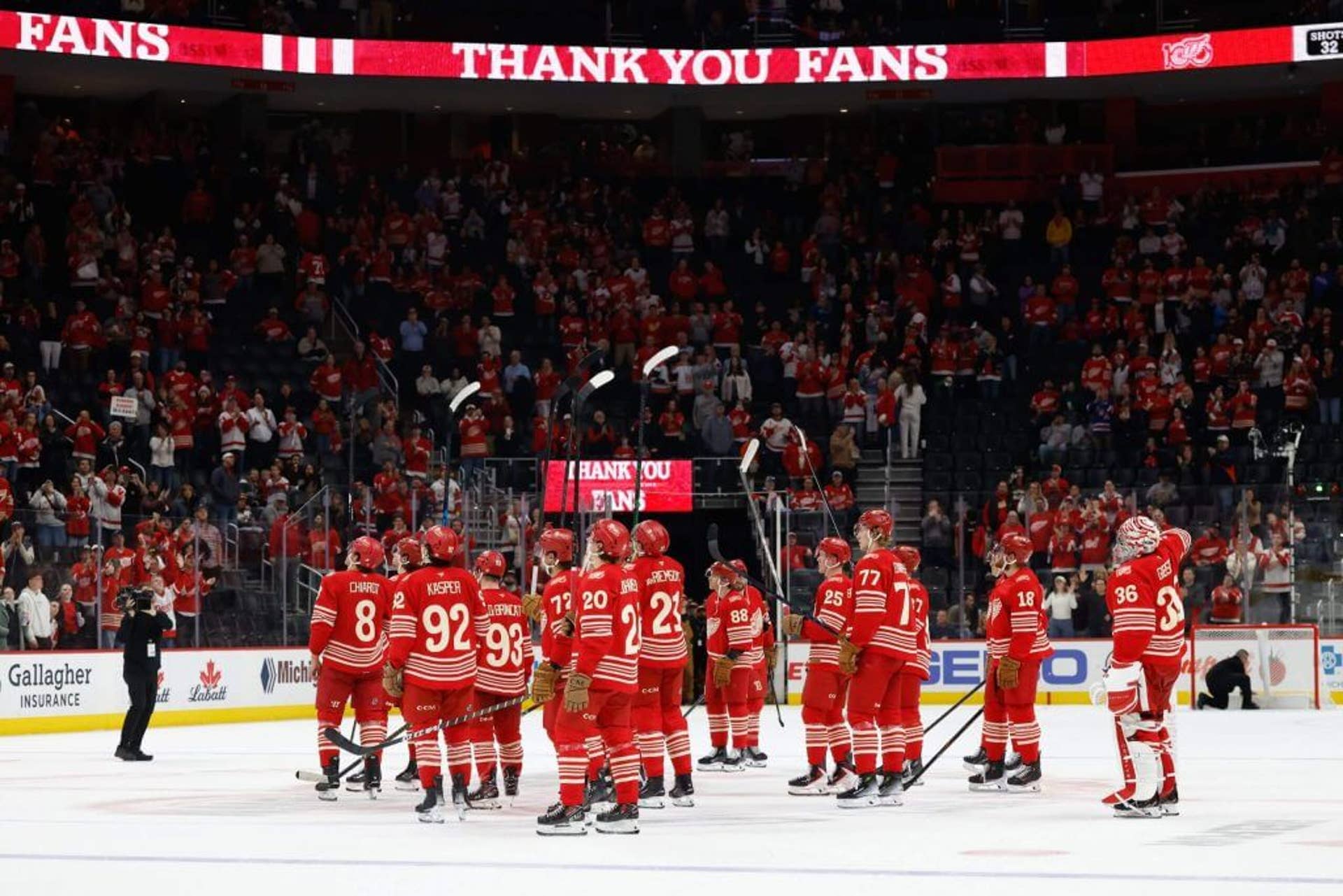 Detroit Red Wings players salute their fans from the ice.