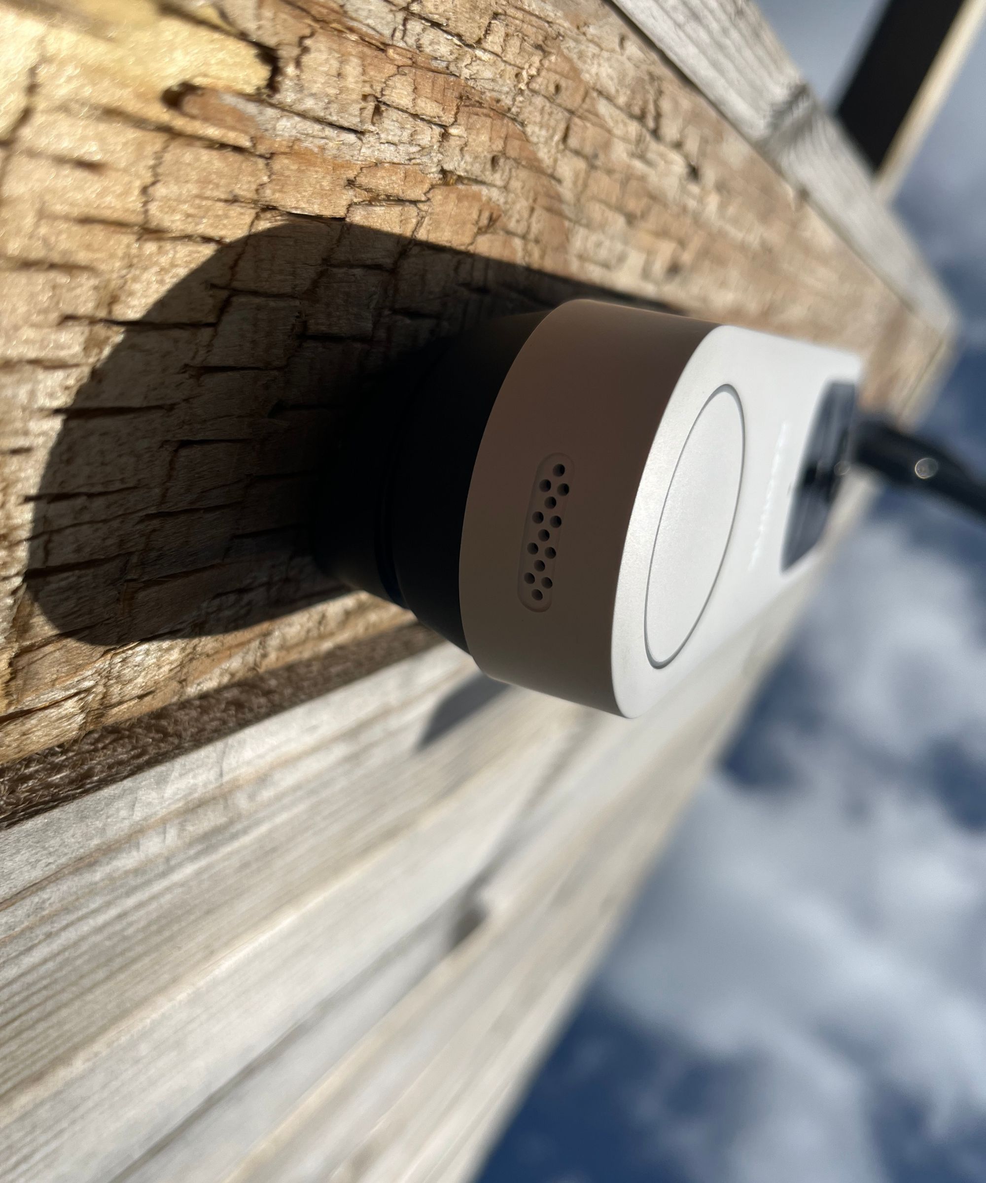 View underneath the Reolink video doorbell (battery) attached to fence, looking at the speaker.