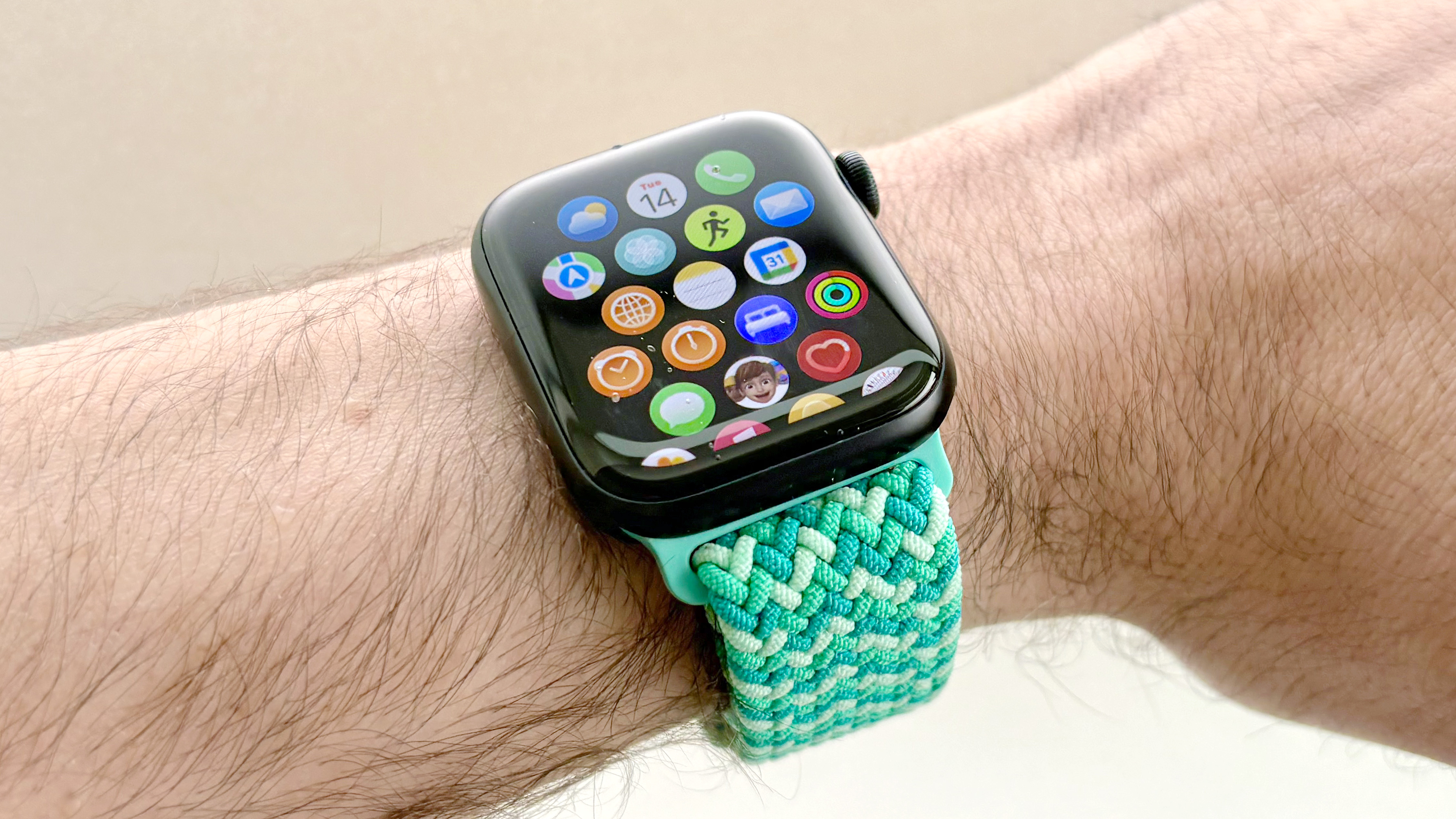 Close-up of the Apple Watch SE 3 on a turquoise strap