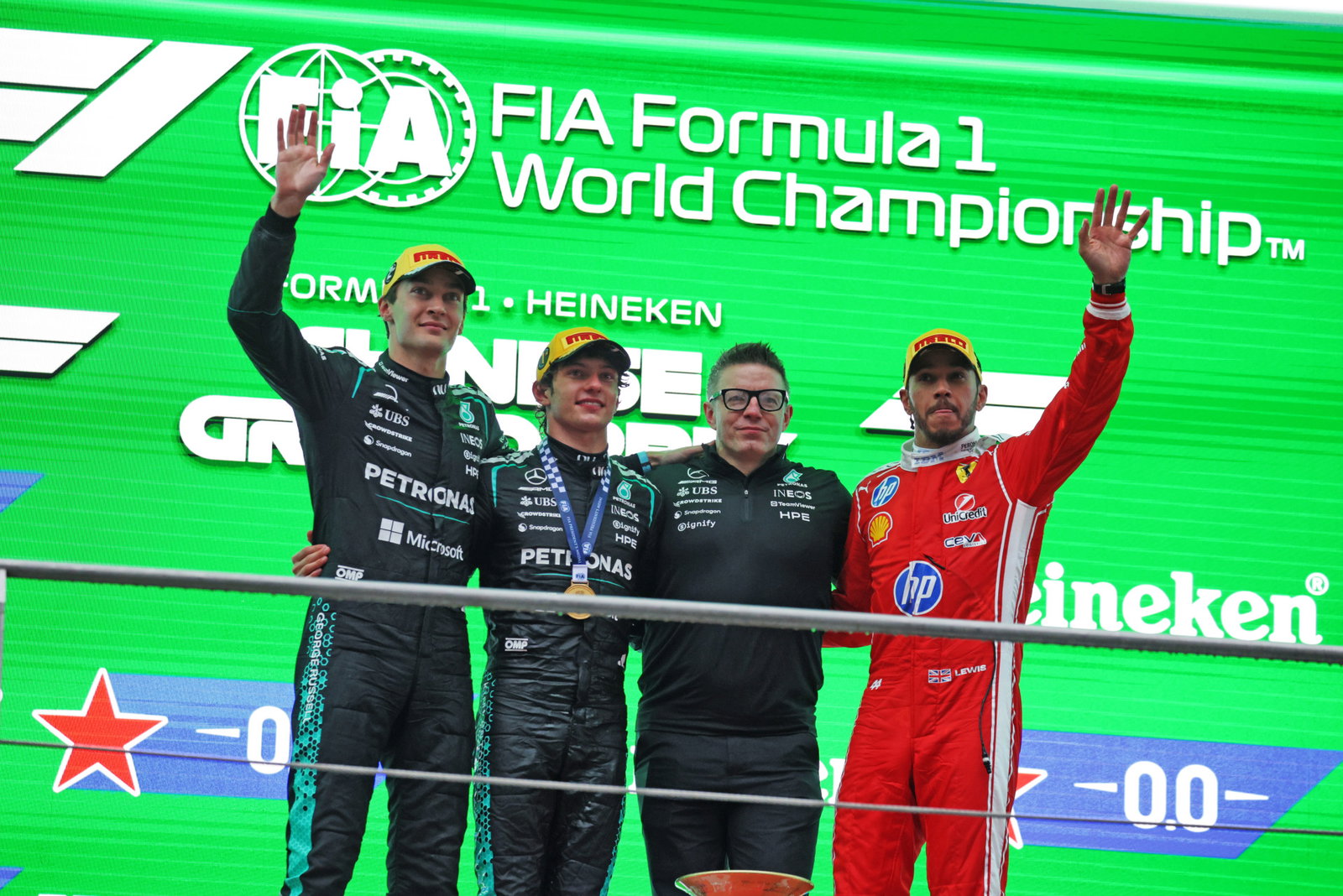 George Russell Kimi Antonelli and Lewis Hamilton alongside Peter Bonnington on the podium which celebrates the top 3 drivers at the Chinese Grand Prix in 2026