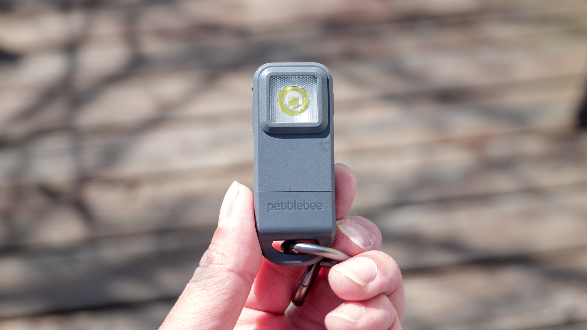 Pebblebee Halo held in the hand.