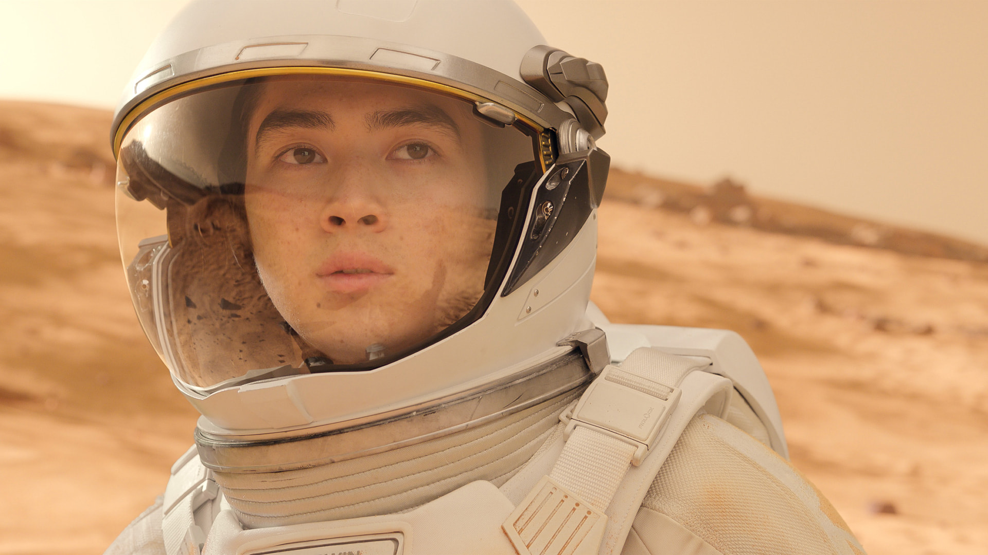 a young man in a spacesuit on Mars
