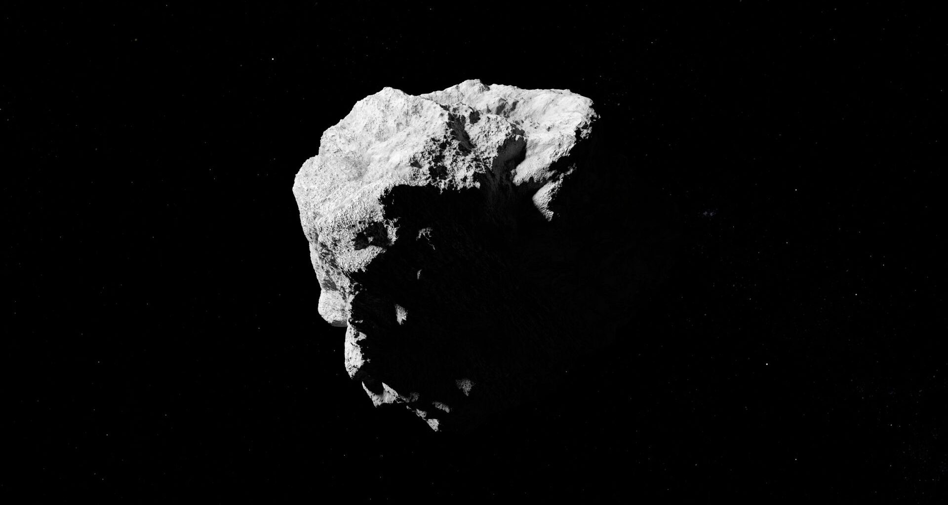 A rocky asteroid is pictured against the black of space.