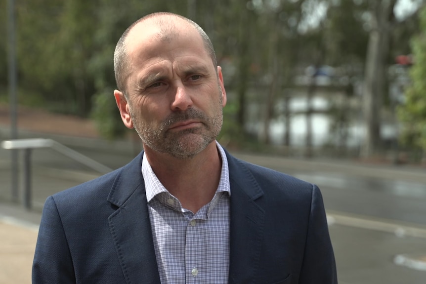 A man in a suit being interviewed