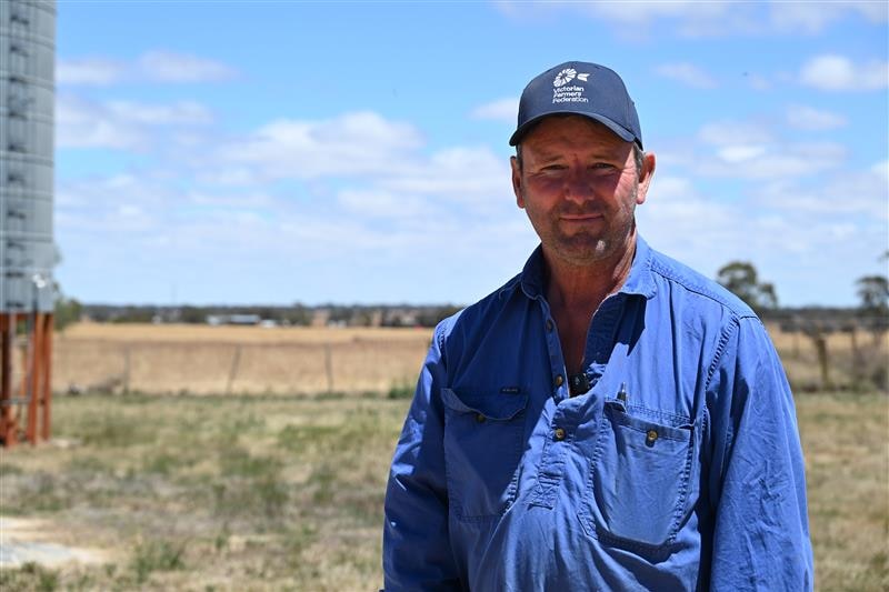 A man in a blue shirt in on farm 
