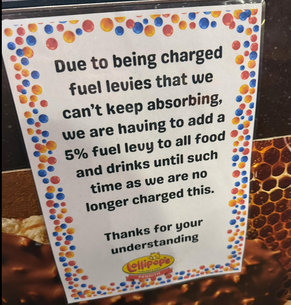 A sign informing customers of a fuel levy surcharge