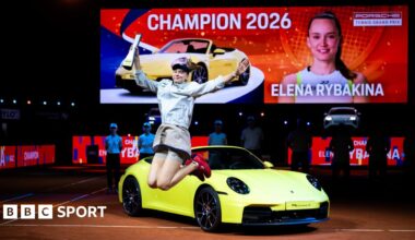 Elena Rybakina celebrates her victory in Stuttgart in front of the sports car that forms part of her winner's prize