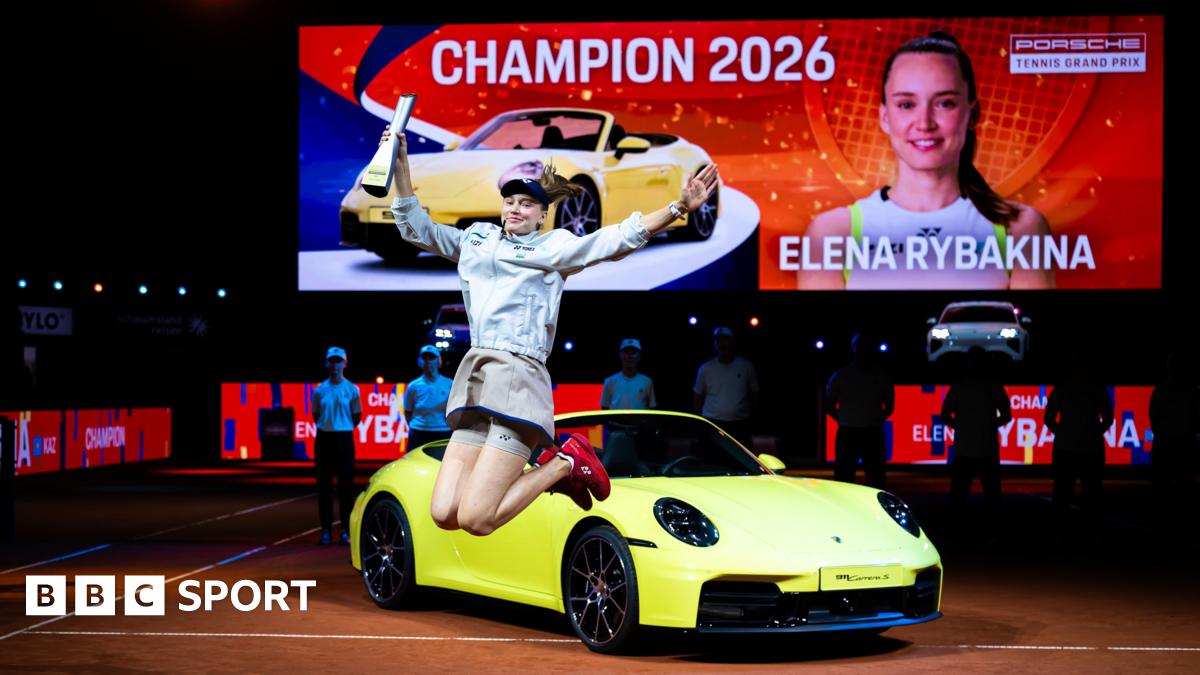Elena Rybakina celebrates her victory in Stuttgart in front of the sports car that forms part of her winner's prize