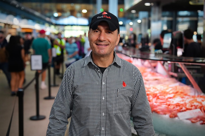 A man at a busy fish market
