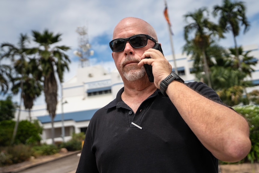 A man, 40s with sunglasses on on phone