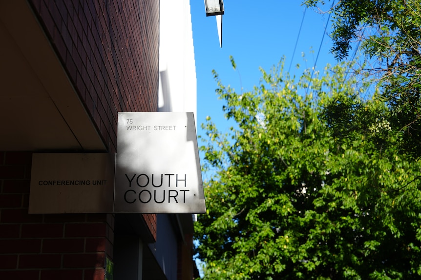 A stainless steel sign showing words Youth Court and 75 Wright Street