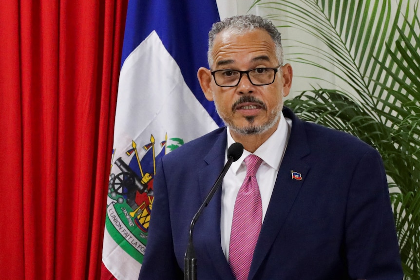 A man looking at the camera in a suit