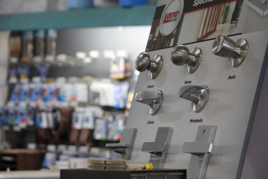 Display of door handles inside hardware store