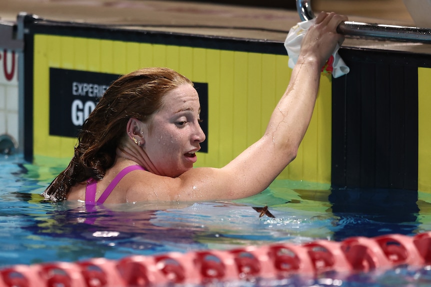 Mollie O'Callaghan looks down at a moth