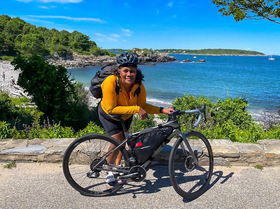 Cyclist with a bike near a coastal view