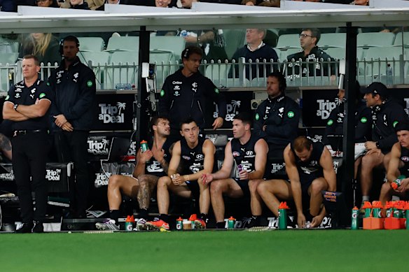Elijah Hollands (right) on the bench in the last quarter.