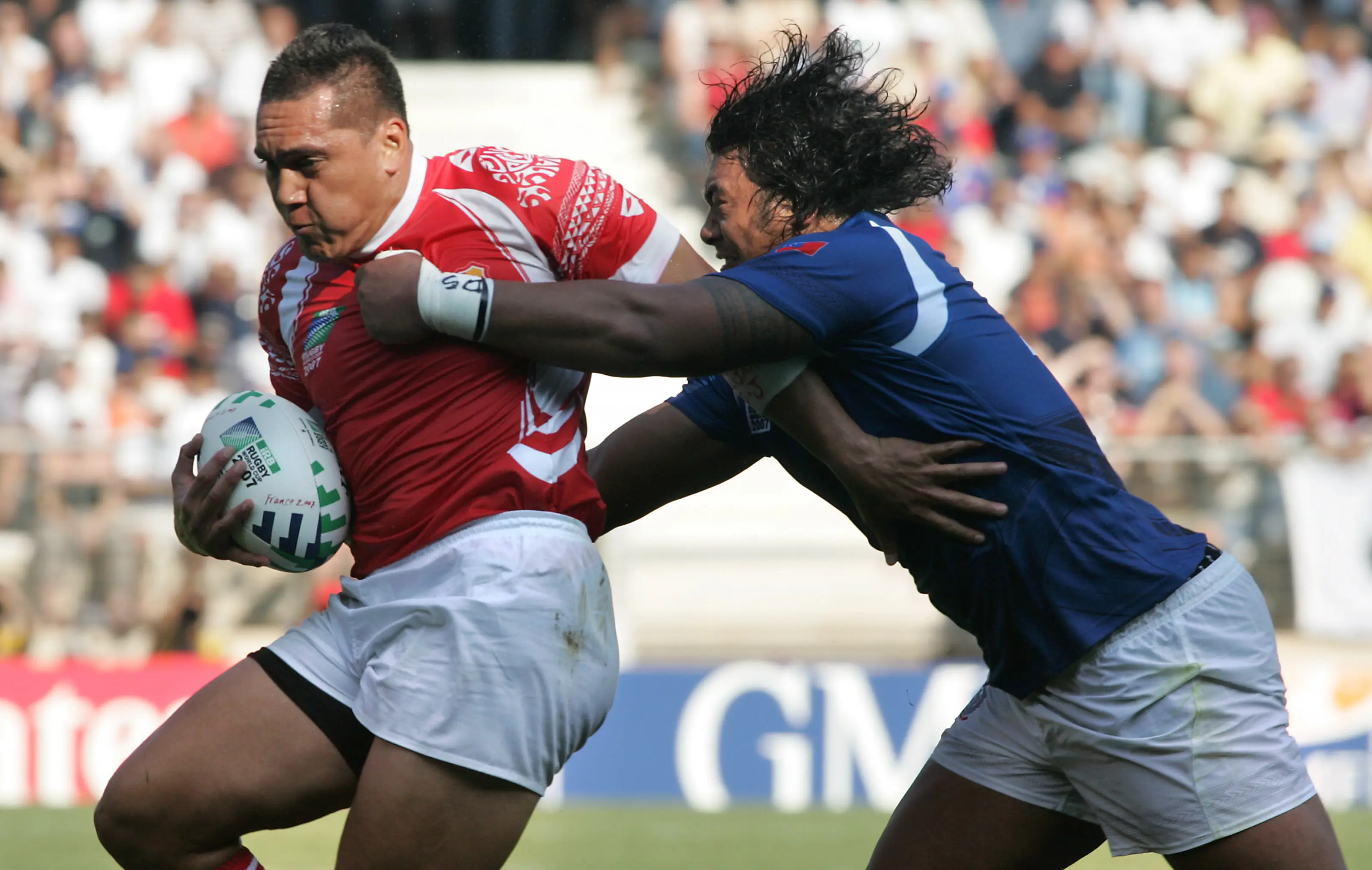 Tonga's fly-half Raymond Pierre Hola (L) vies with an unidentified Samoa's player during their rugby union World Cup group A match Samoa vs. Tonga (Getty Images)
