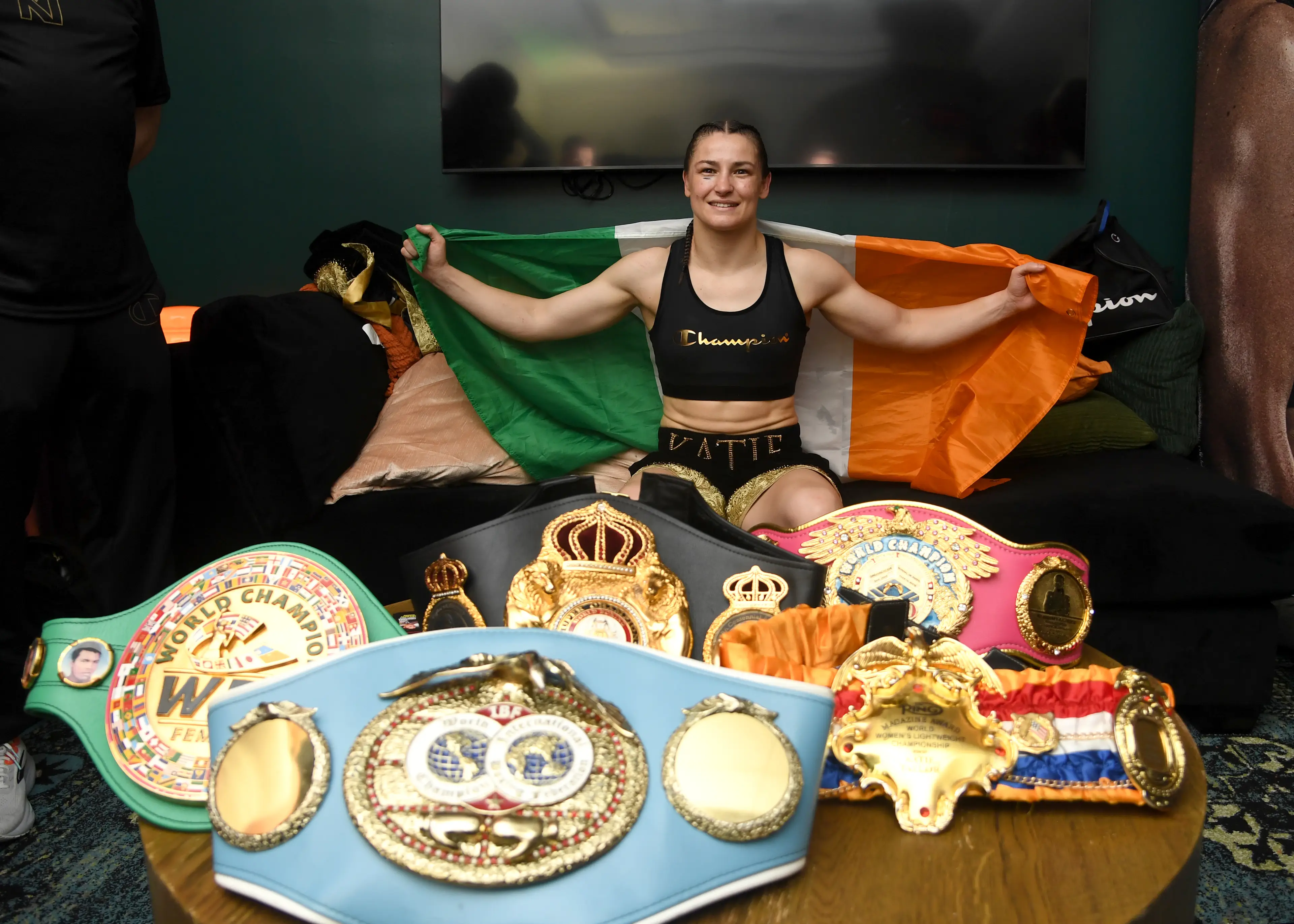 Katie Taylor celebrates in her dressing room after defeating Amanda Serrano by a majority decision in their undisputed IBF, WBA, WBC, WBO, and Ring super lightweight championship  (Getty Images)