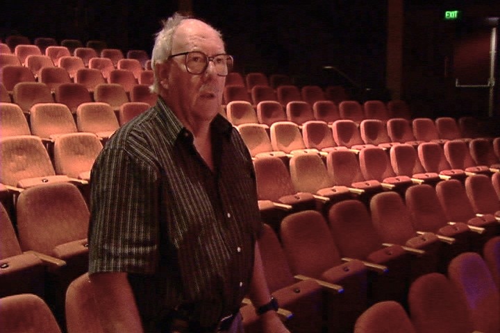 A man watching a performance from theatre seating