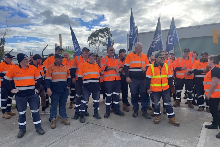 A group of people in high vis with union flags.