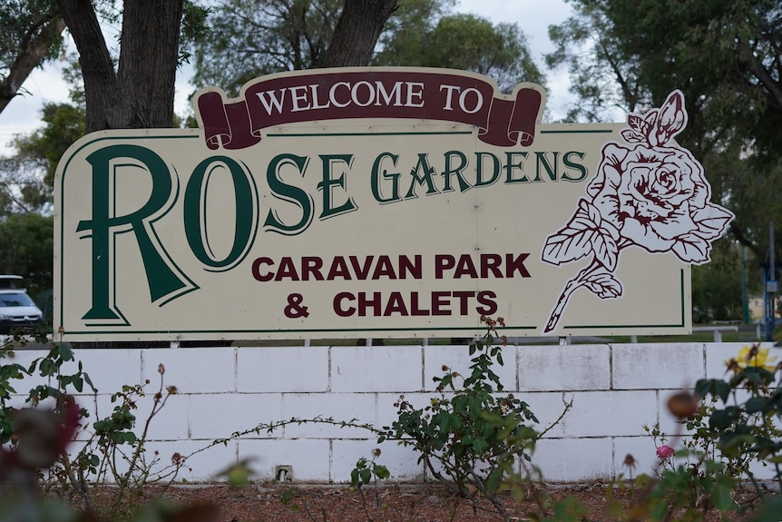 A sign which reads 'Welcome to Rose Gardens'