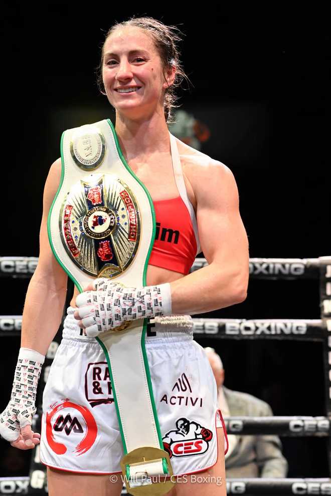 Amelia Moore with NABF lightweight title belt