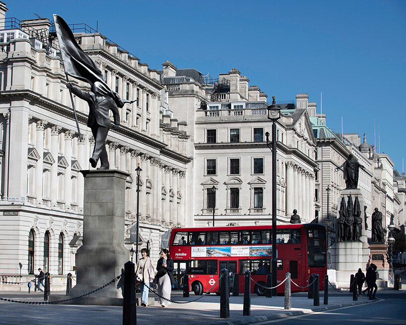 anonymous flag-bearer by banksy walks among london's historic monuments - 1