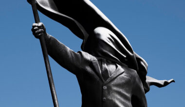 anonymous flag-bearer sculpture by banksy appears in london