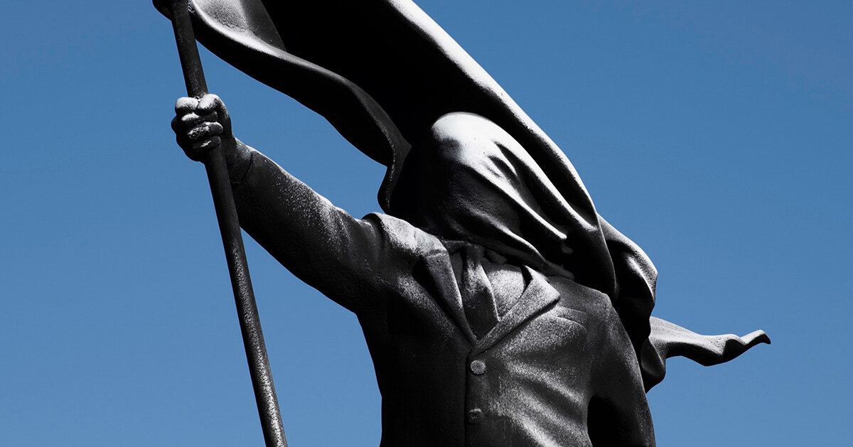 anonymous flag-bearer sculpture by banksy appears in london