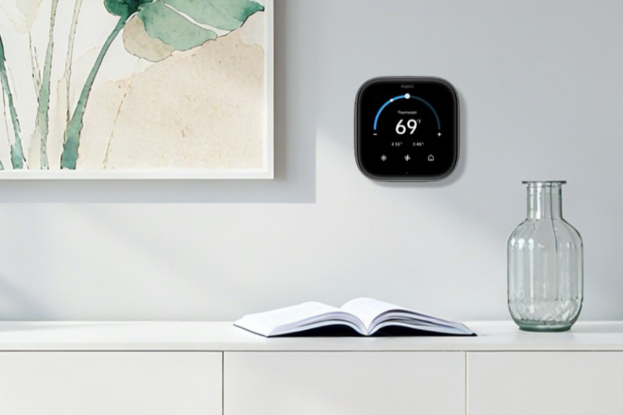 The Aqara Thermostat Hub W200 on a wall next to a painting.