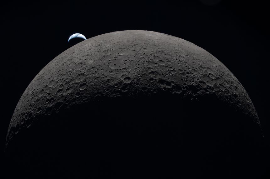 Earth sets behind the moon on Monday, April 6, during the lunar flyby of the Artemis II mission.
