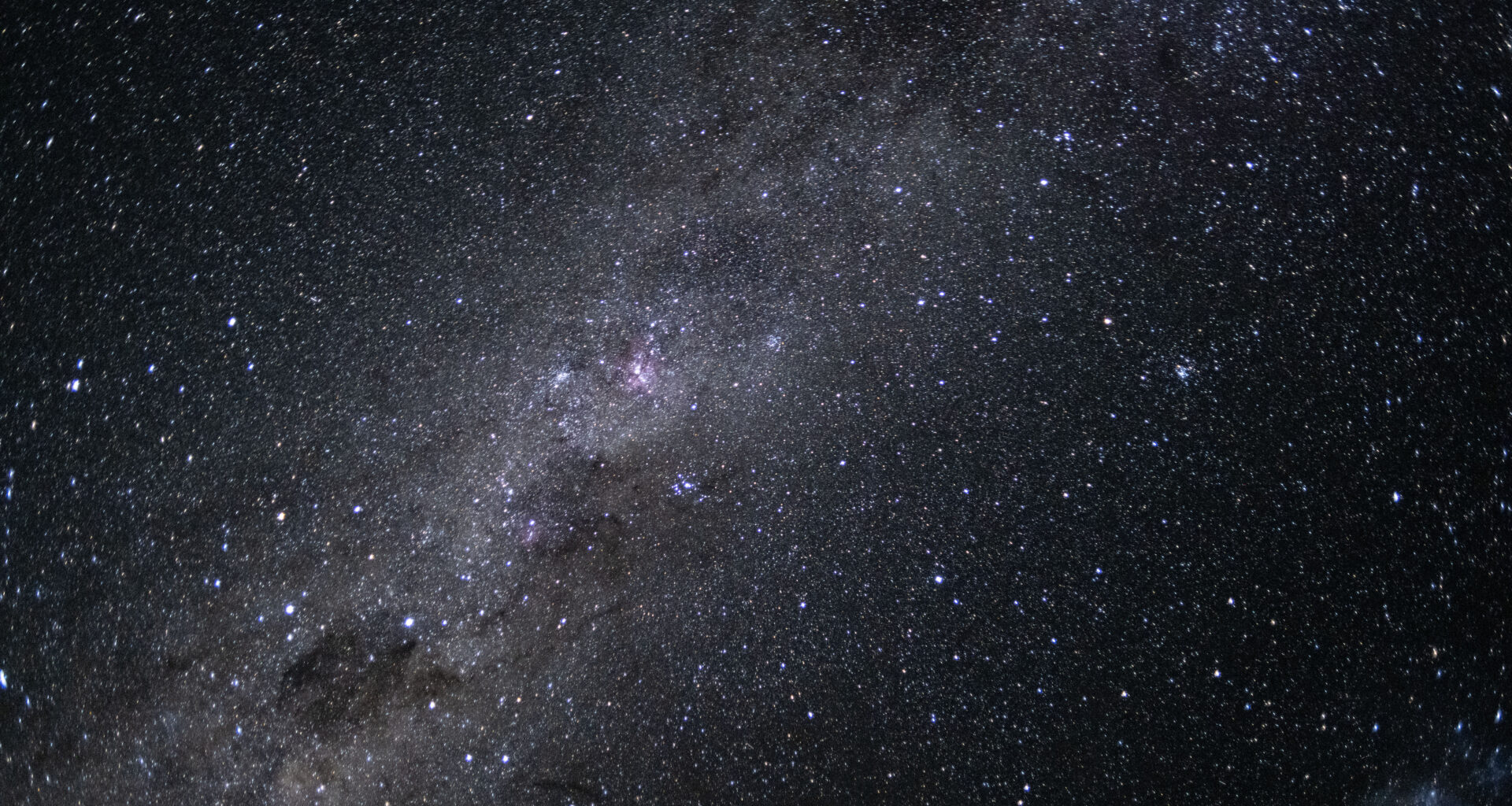 The Milky Way galaxy appears as many points of light dotting the blackness of space.