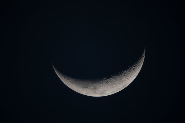 Crescent moon seen against the darkness of space
