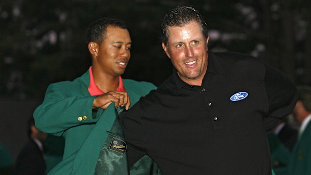 Phil Mickelson receives his green jacket from Tiger Woods after winning the 2006 Masters at the Augusta National Golf Club in Augusta, Georgia on April 9, 2006. (Photo by Hunter Martin/WireImage)