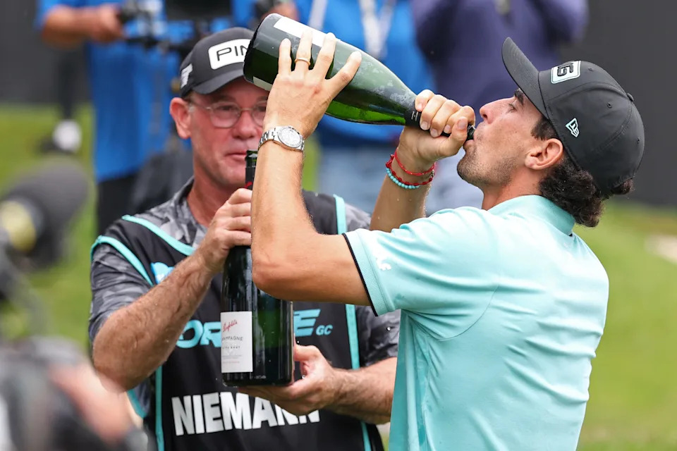 Joaquin Niemann of team Torque GC celebrates with caddie Gary Matthews after winning the LIV Golf Virginia golf tournament at Robert Trent Jones Golf Club.