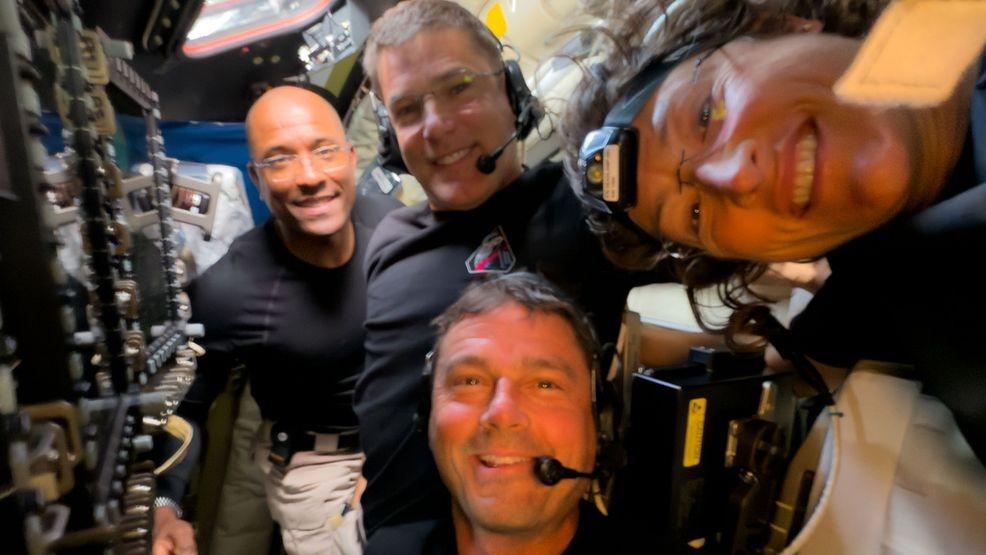 In this image provided by NASA, Artemis II crew members, from left, Victor Glover Jeremy Hansen, Victor Glover, Reid Wiseman and Christina Koch, pause to turn the camera around for a selfie midway through their lunar observation period of the Moon during a lunar flyby, Monday, April 6, 2026. NASA via AP)